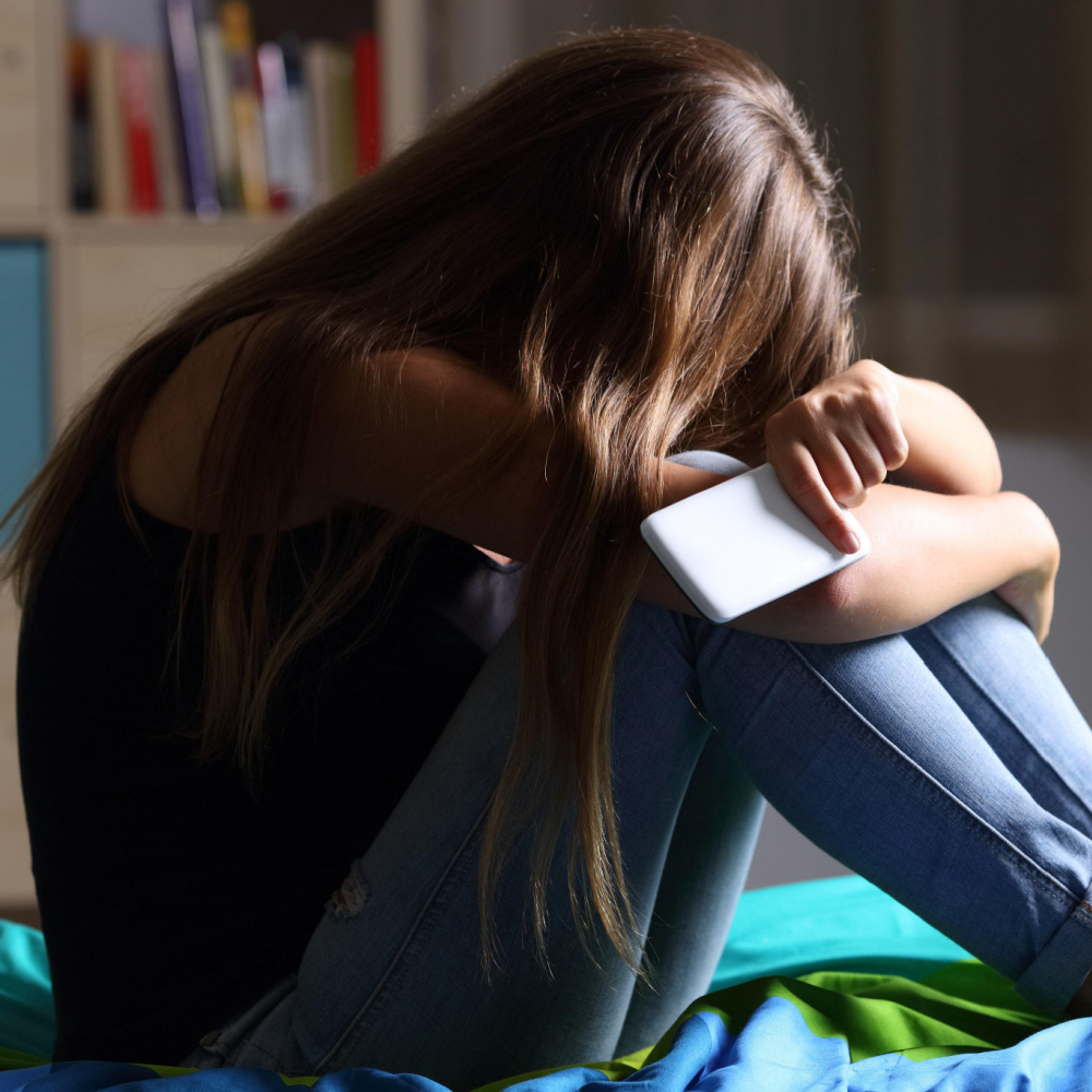 Girl with Her Head in her Knees | What is Frapping in Cyberbullying? | The Effects of Being Cyberbullied