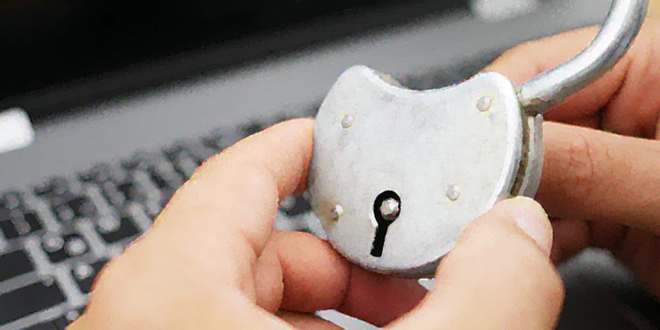 Person Holding A Lock In Front Of A Computer | Is Protecting Privacy An Act Of Faith | Public Square Magazine | Does God Give Us Privacy? | Bible Verse About Being Private